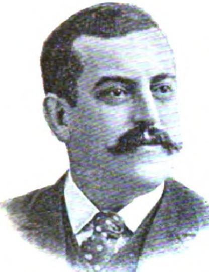 Clean-shaven man with dark hair in formal attire