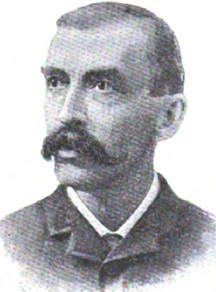 Man with dark hair and mustache in high-collared formal wear
