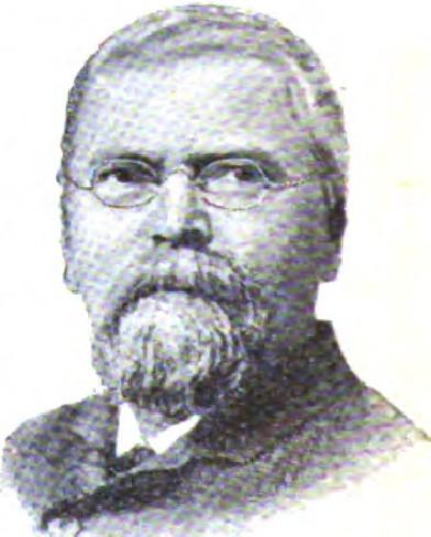 Man wearing glasses with gray beard in formal attire