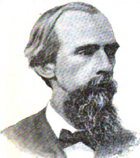 Man with receding hairline and full beard in dark formal wear