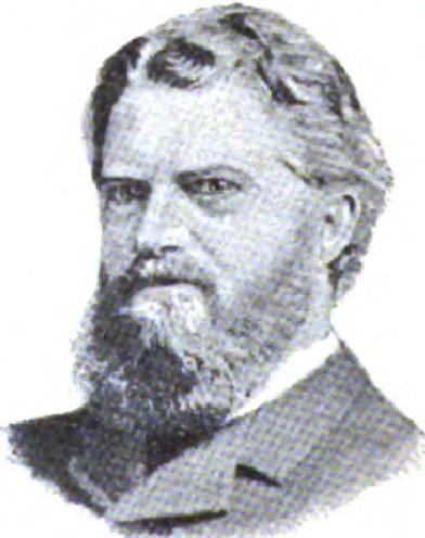 Man with wavy hair and full beard in formal wear
