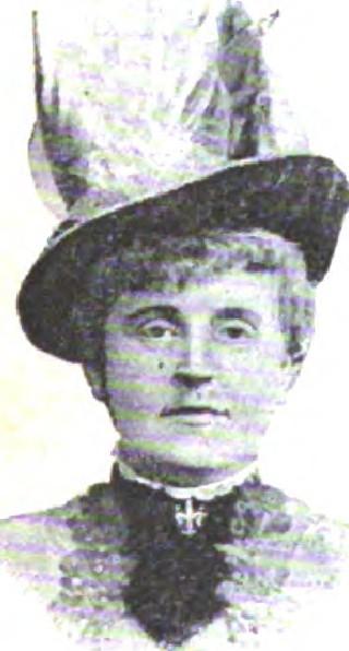 Woman wearing decorated hat and high-necked Victorian dress
