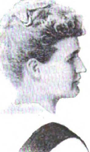 Woman in profile with curled hair wearing formal attire