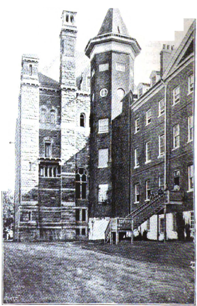 Stone university building showing clock tower and architectural details from corner angle